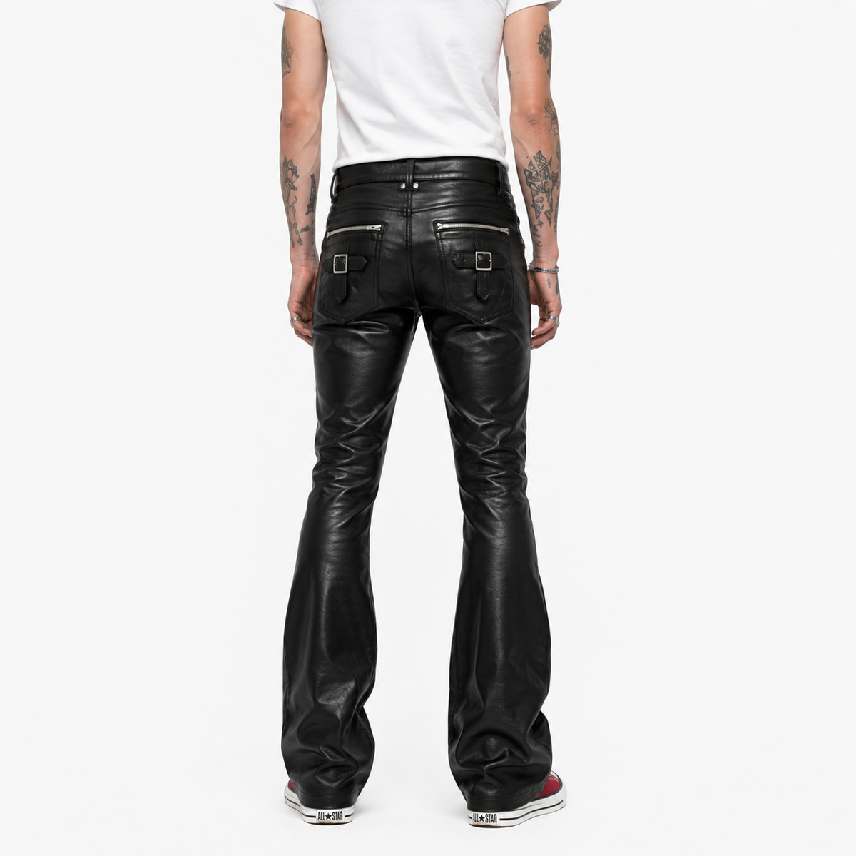 Back view of black leather pants showing buckle strap pocket detail and bootcut flare