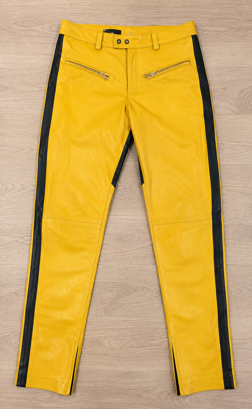 Yellow leather motorcycle pants with black side stripe, front flat lay