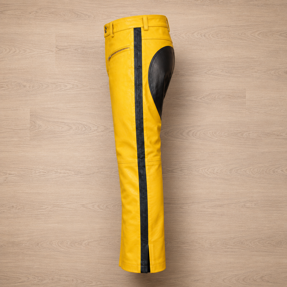 Close-up of black side stripe on yellow leather pants leg